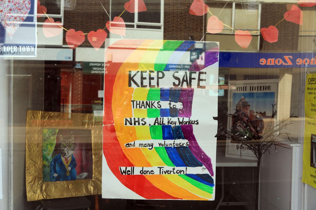 A hand-painted rainbow poster in a Tiverton shop window thanking the NHS and key workers