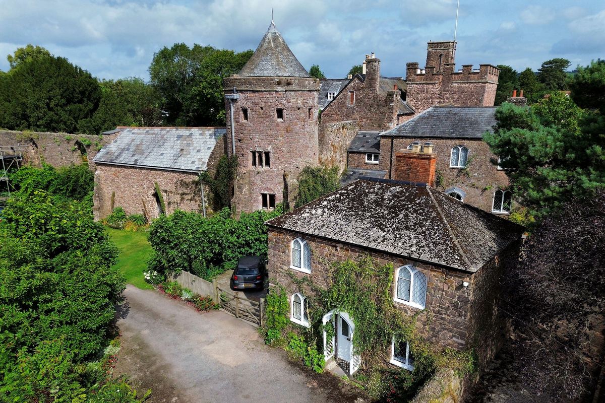 Tiverton Castle seen from above, with its gatehouse and gardens